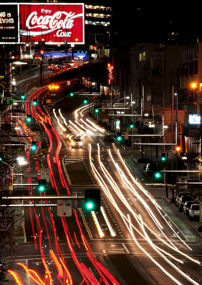 Traffic in Potts Point near the Coca Cola Sign.